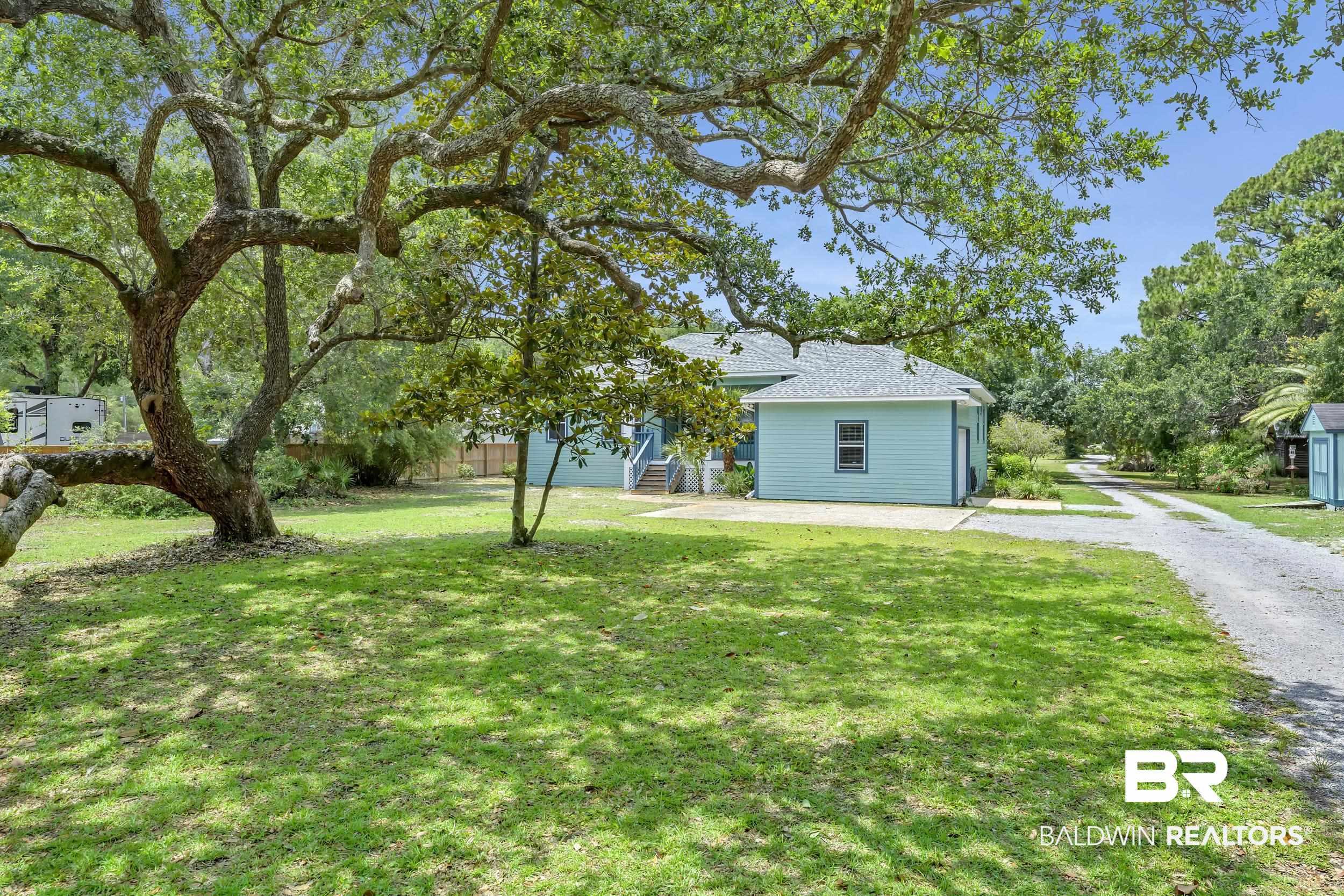 Image 3: Expansive lawn featuring mature trees providing ample shade