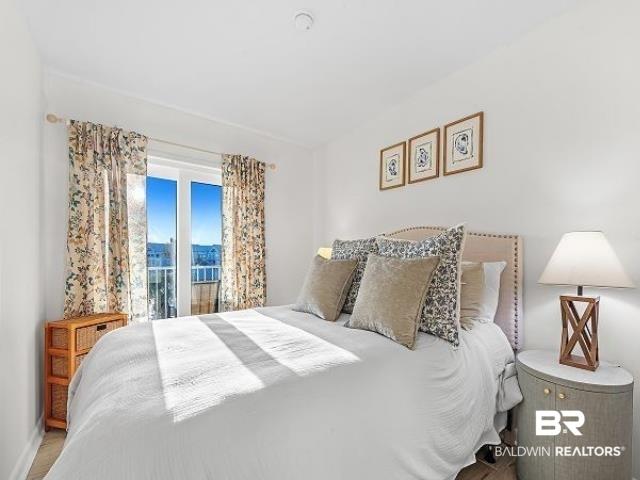 Image 2: Room featuring light-colored walls and a double door leading to an exterior balcony