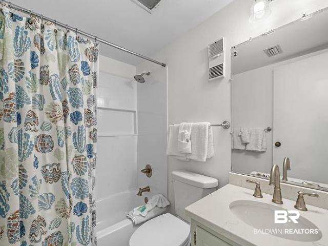 Image 3: Full bathroom featuring a white tub/shower combination, brushed nickel fixtures, a vanity with an integrated sink, and a wall-mounted mirror