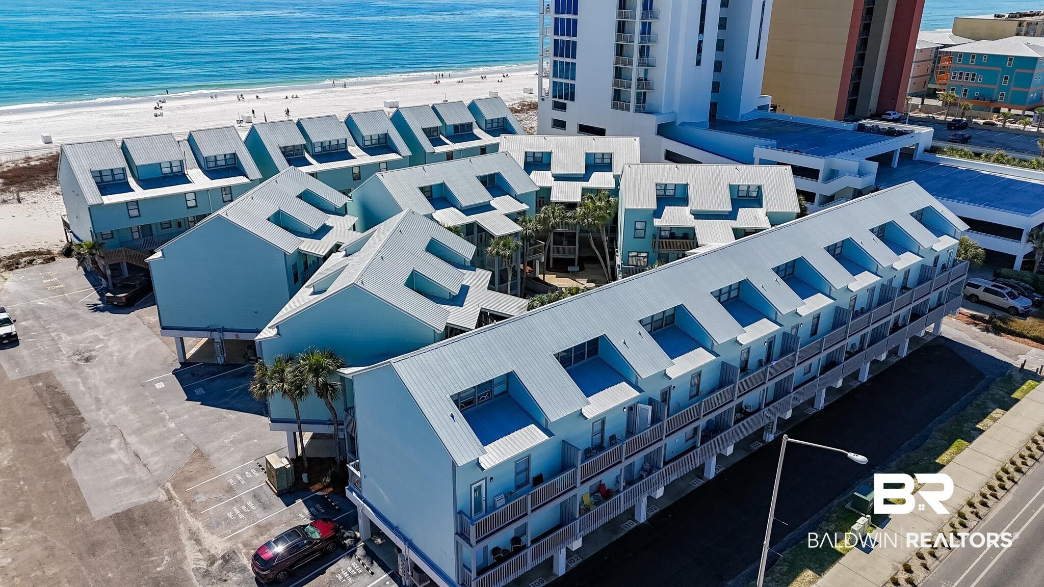 Image 2: Birds eye view of property with a water view and a view of the beach