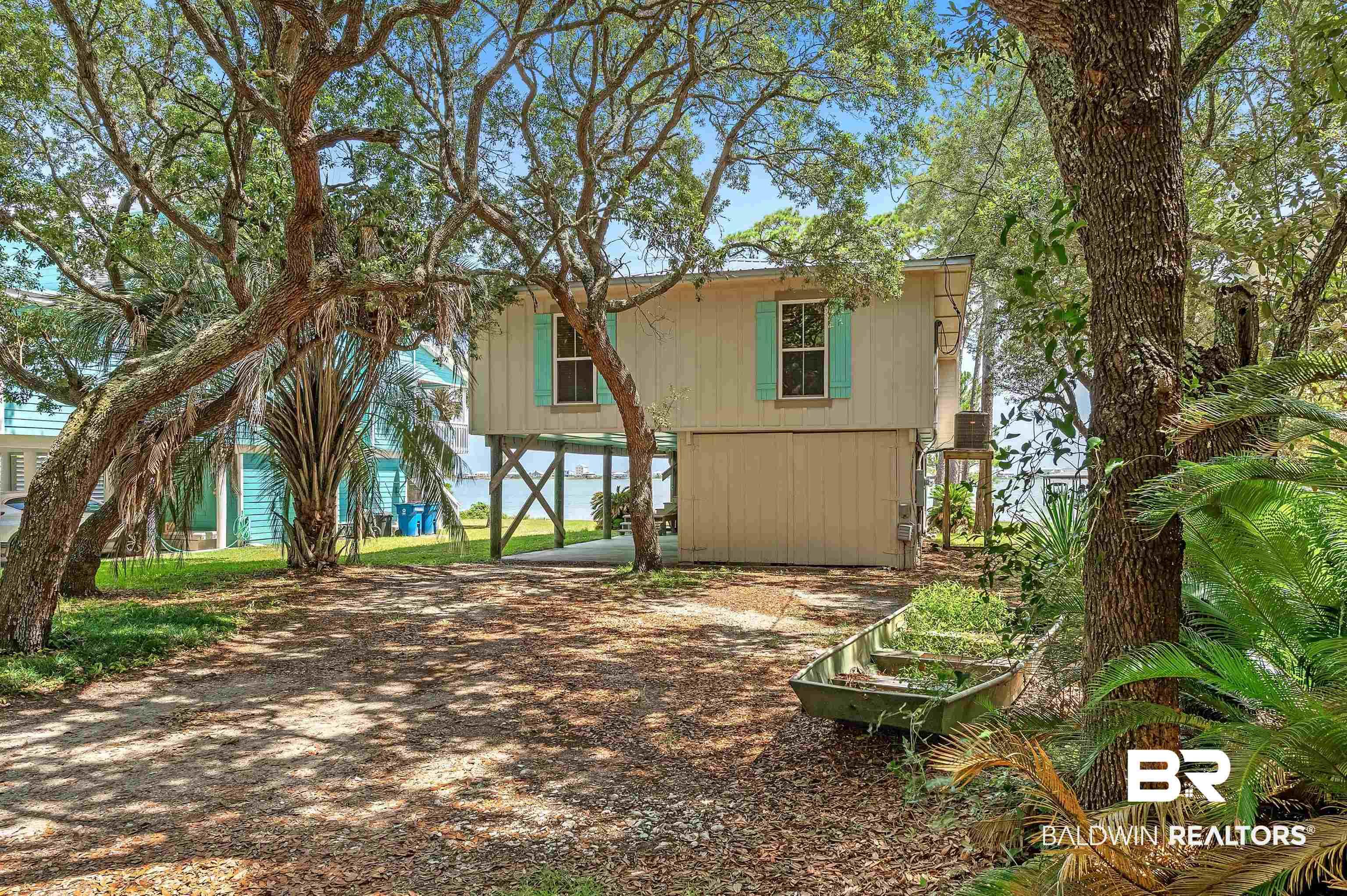 Image 4: View of front of home with a carport and driveway