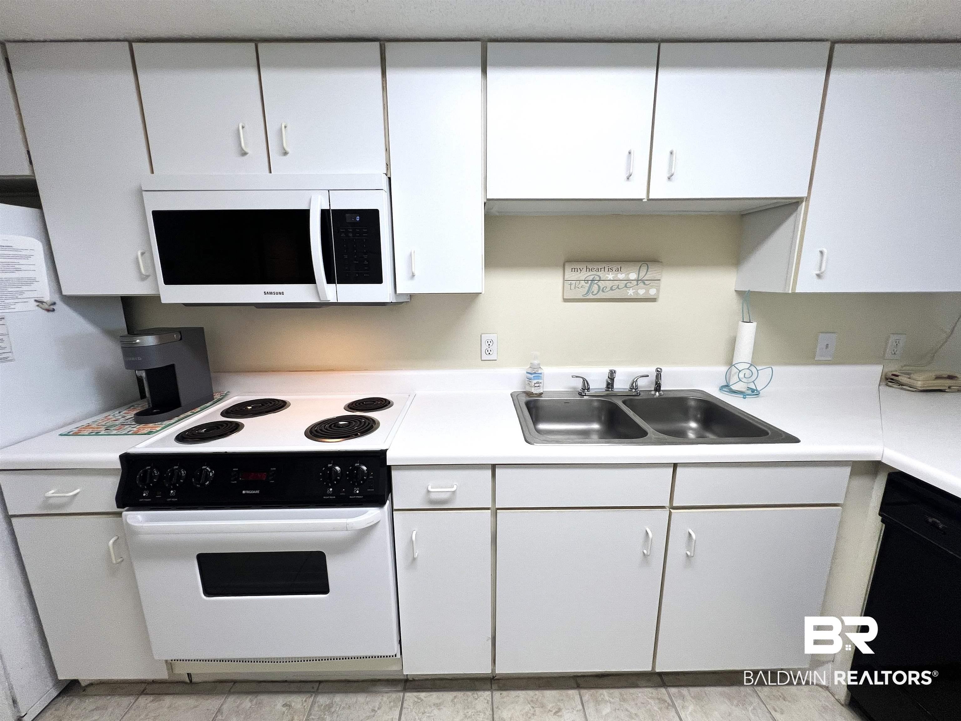 Image 4: Kitchen featuring white cabinetry and countertops