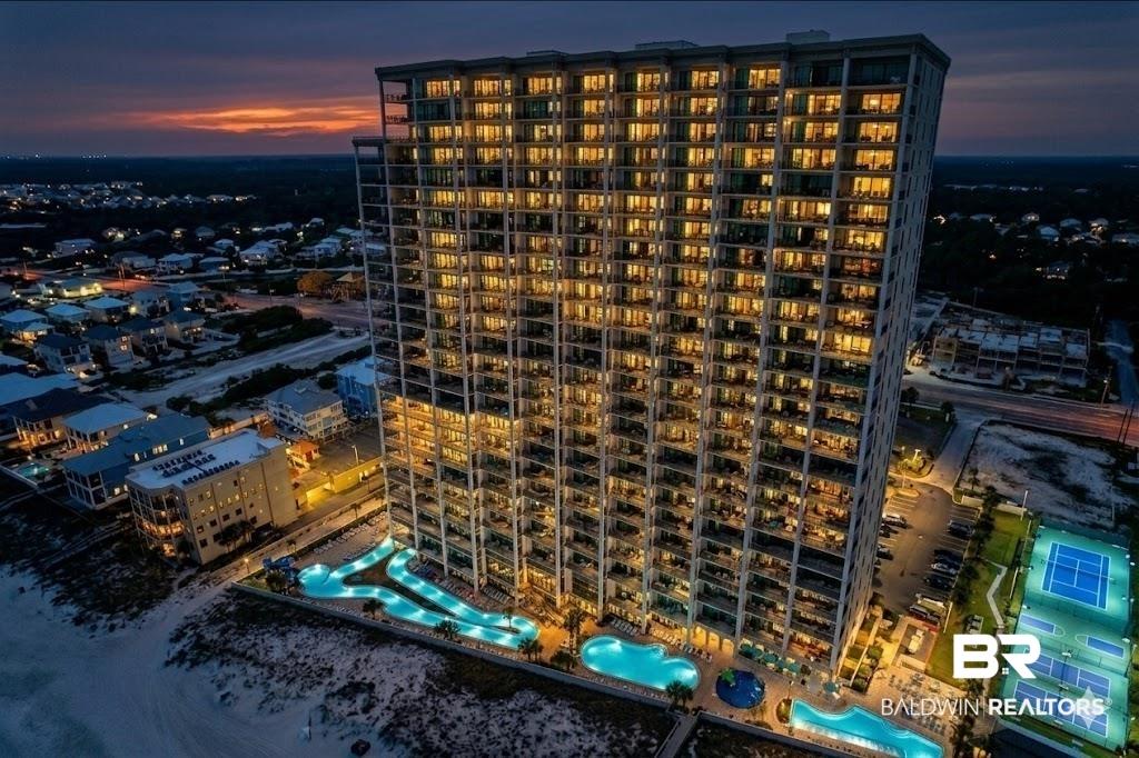 Image 2: Contemporary high-rise building featuring multiple illuminated balconies