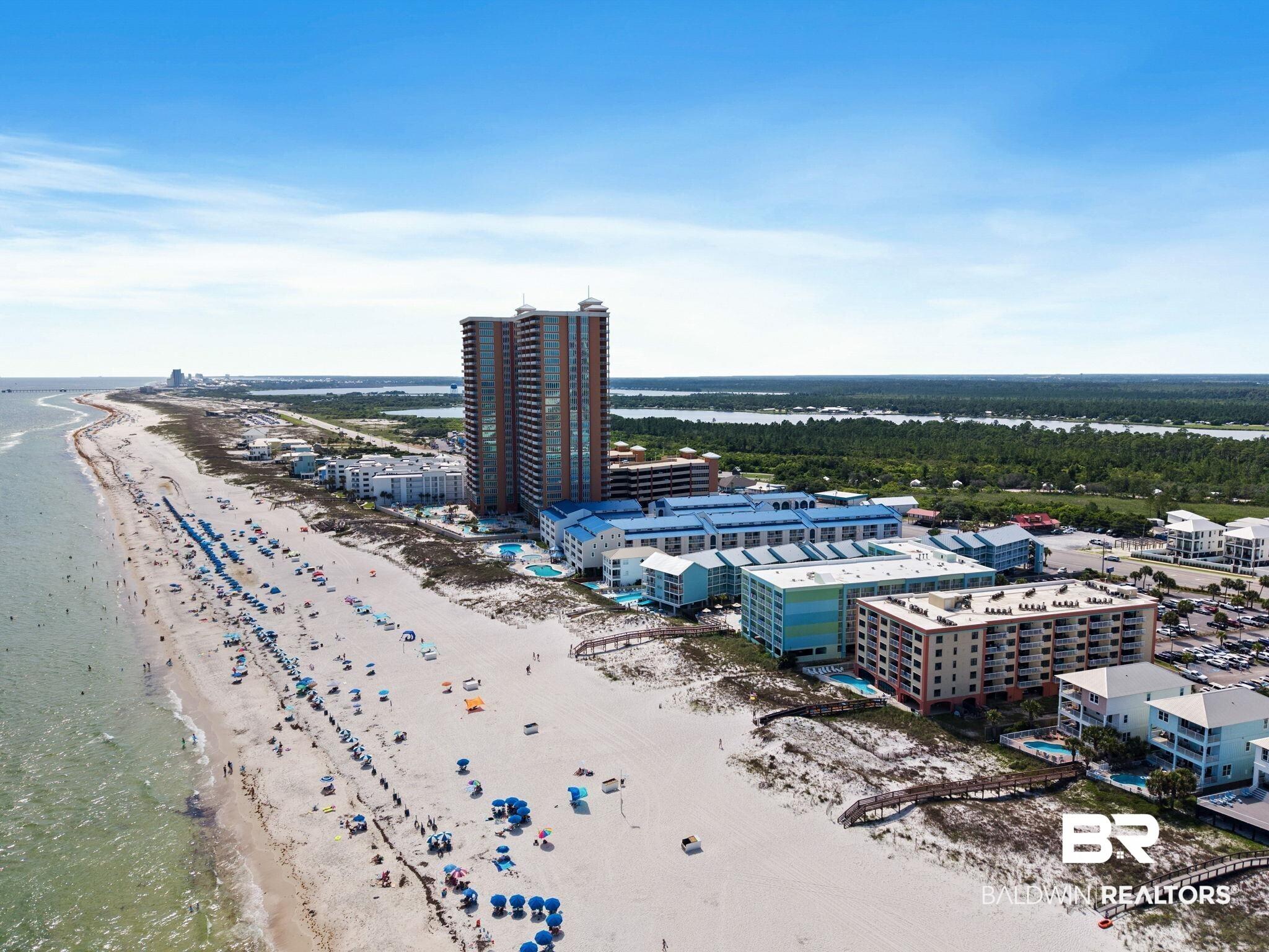 Image 4: Coastal development featuring multiple residential structures along a beachfront
