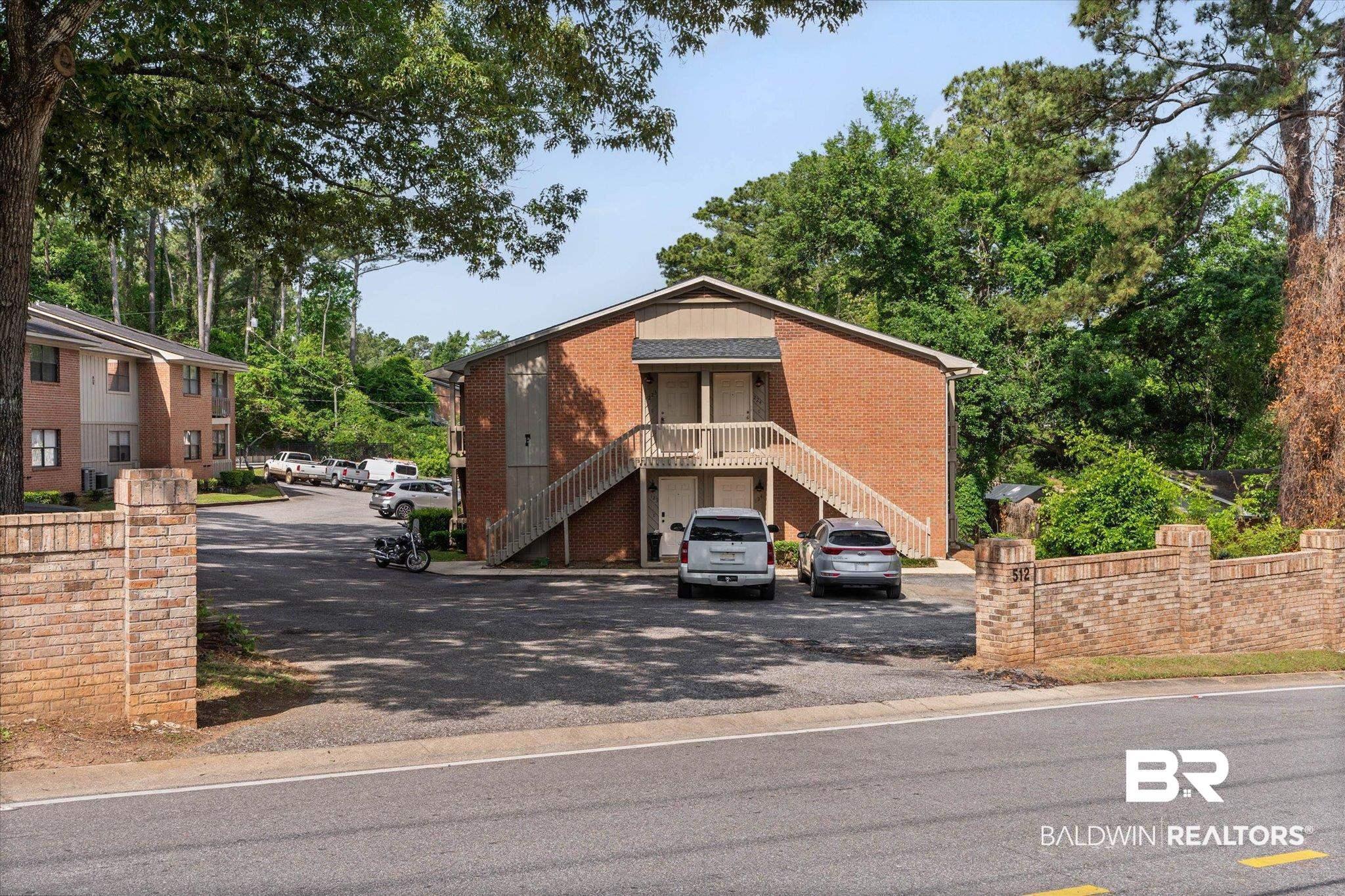Image 3: Multi-unit residential building featuring brick and siding exterior construction