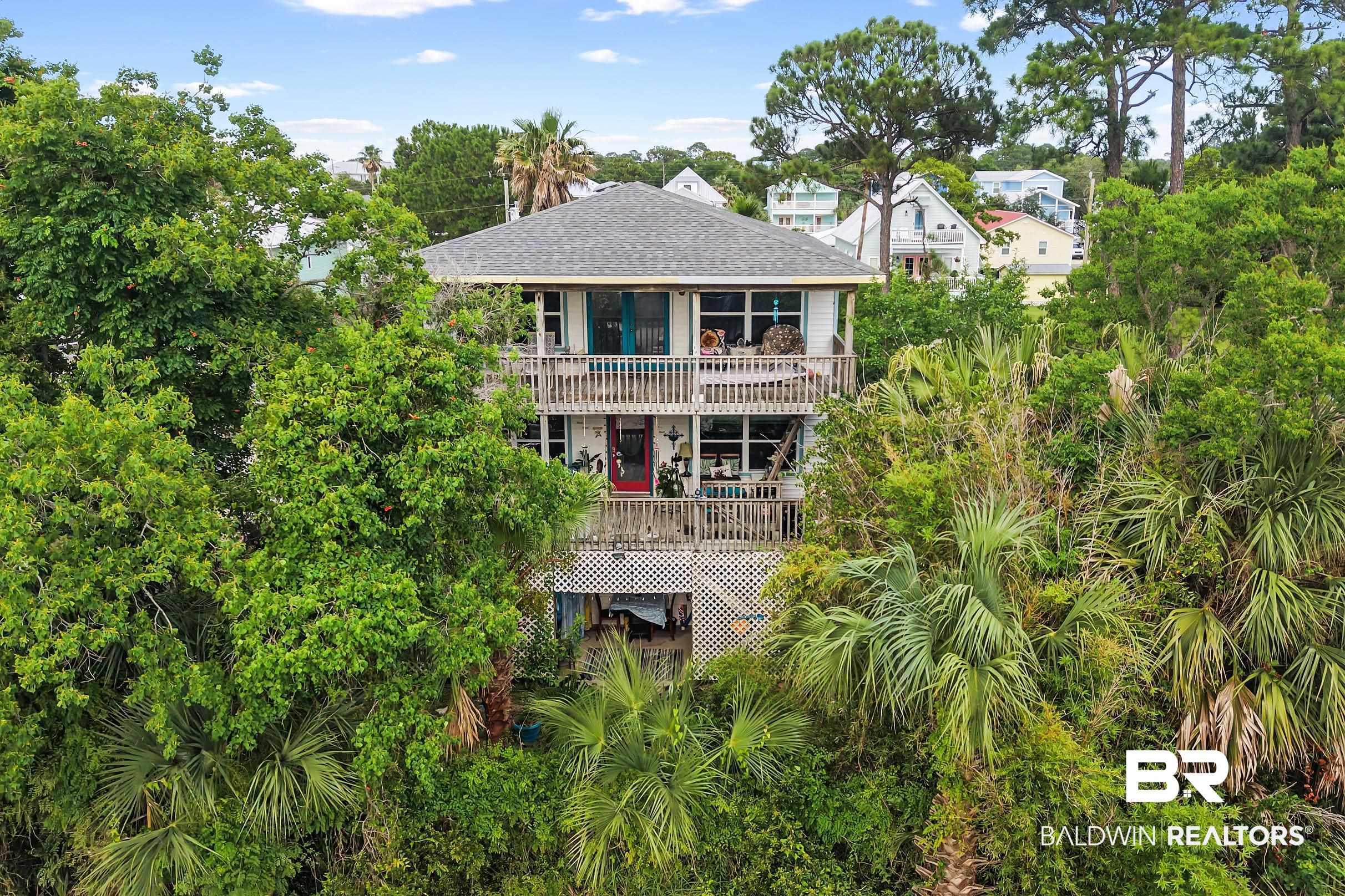Image 2: Multi-story residence featuring a gray shingle roof and multiple balconies