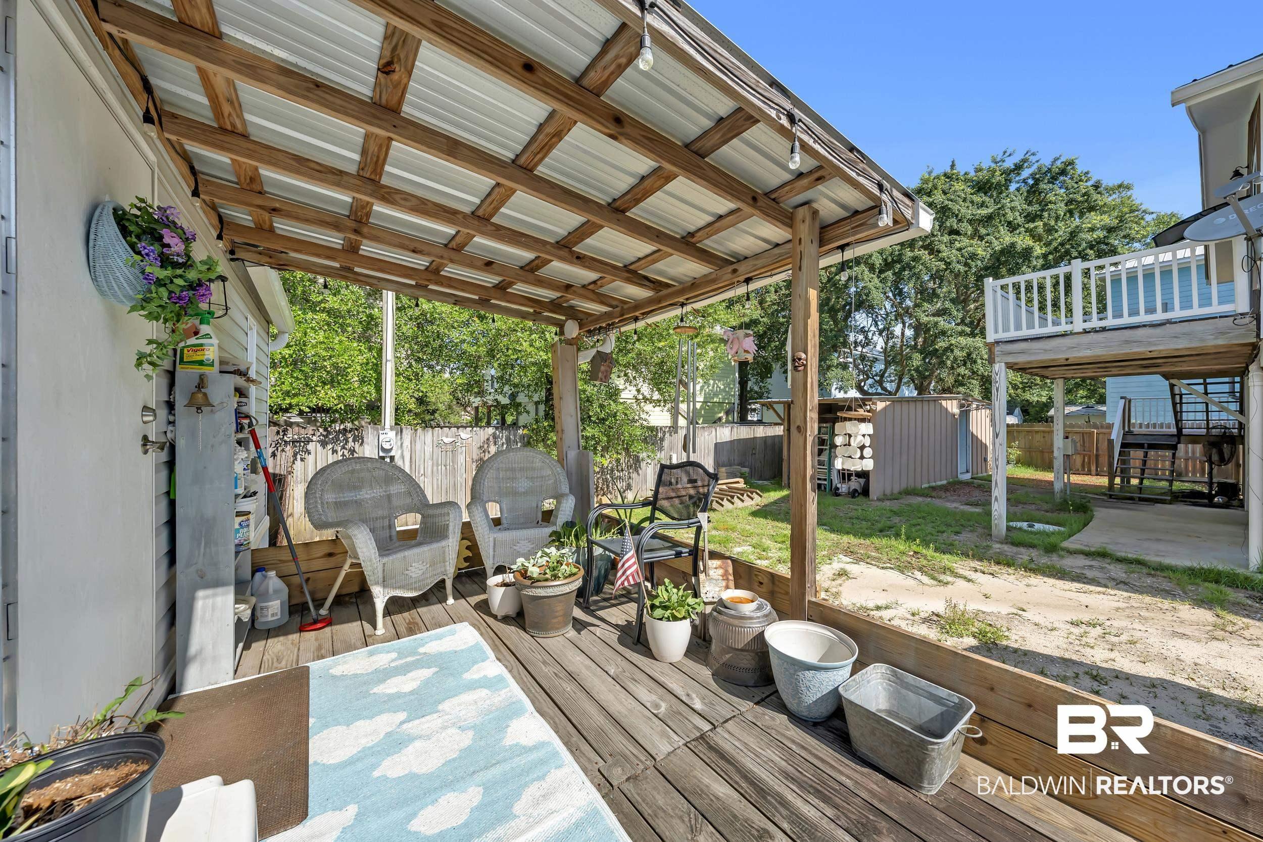 Image 2: Covered wood deck with a corrugated metal roof
