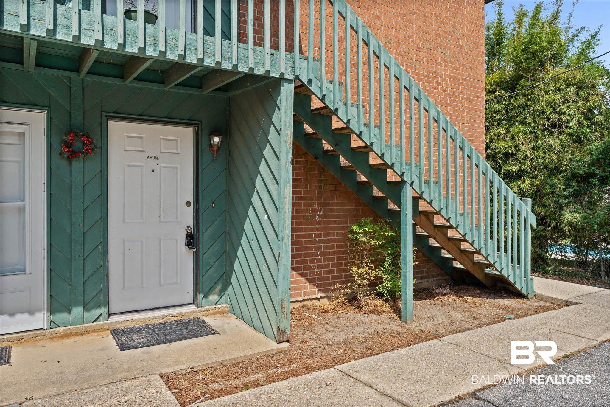 Image 2: Ground-floor entry featuring a white panel door with built-in overhead lighting