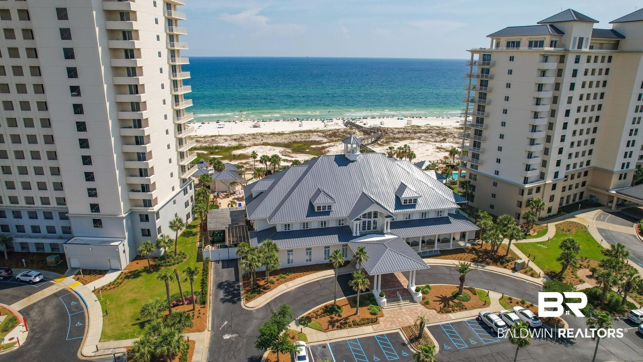 Image 2: Coastal property featuring multiple high-rise buildings and a central amenity structure with a cupola