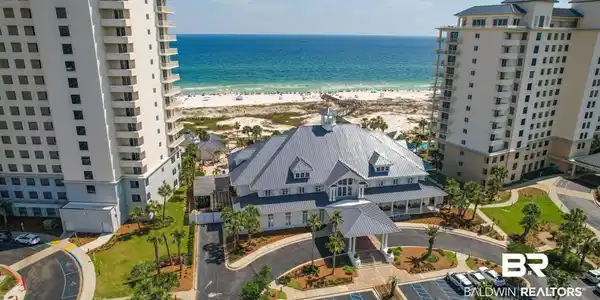 Image 2: Coastal property featuring multiple high-rise buildings and a central amenity structure with a cupola