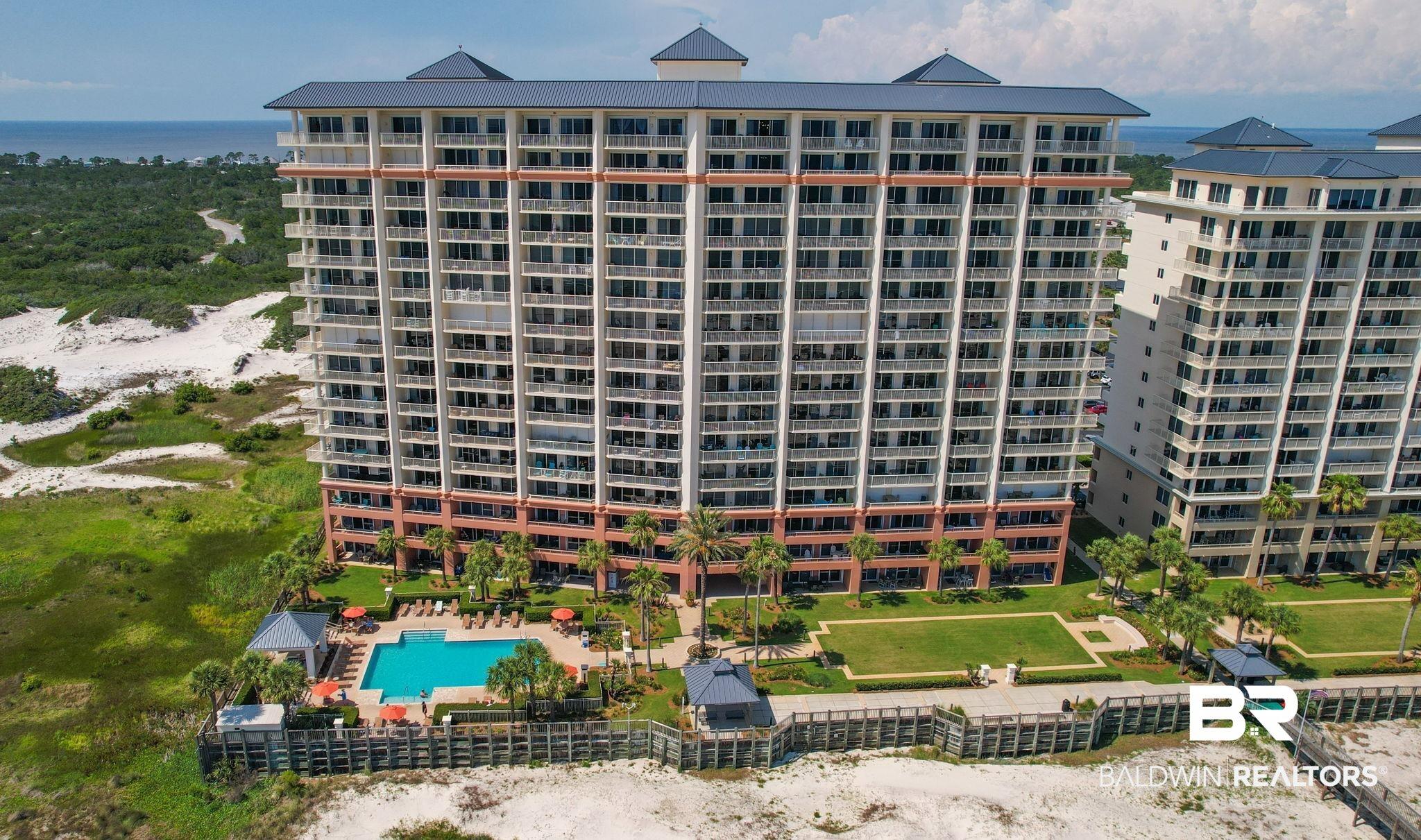 Image 4: Multi-story condominium building featuring numerous balconies and a blue tile roof