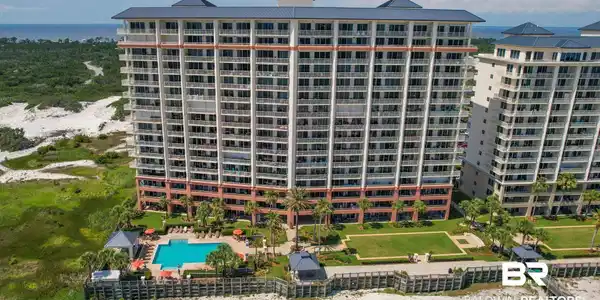 Image 4: Multi-story condominium building featuring numerous balconies and a blue tile roof