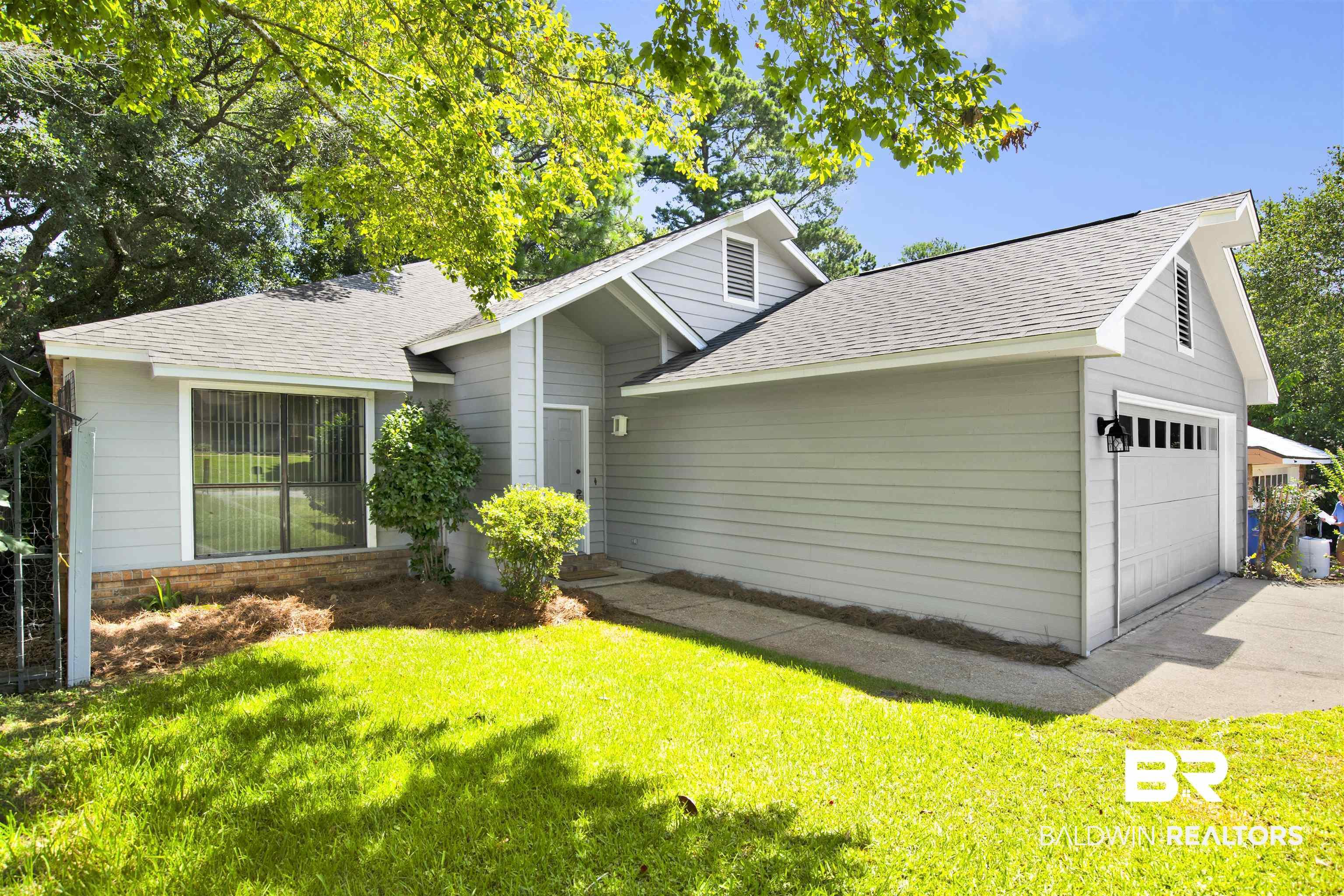 Image 2: Light gray siding exterior with a dark gray shingle roof