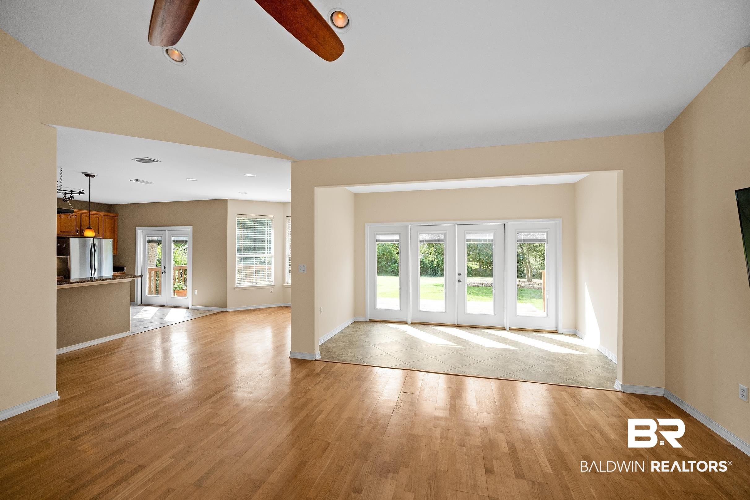 Image 4: Expansive room featuring wood-finish flooring and recessed lighting