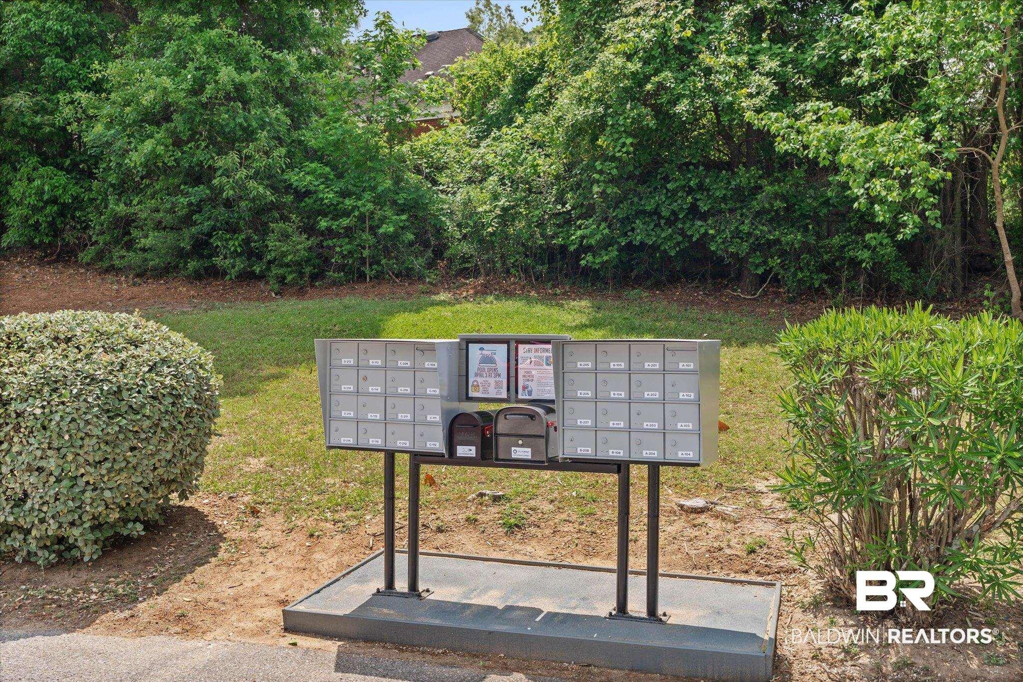 Image 4: Centralized mailbox station featuring multiple individual units, two parcel lockers, and a dedicated information board