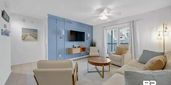 Image 3: Spacious living area featuring a blue accent wall with wainscoting, a ceiling fan, and recessed lighting