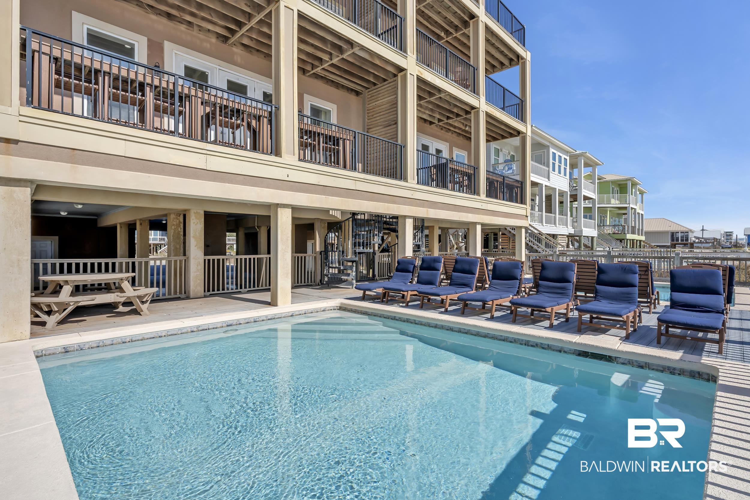 Image 3: Community pool with a patio area