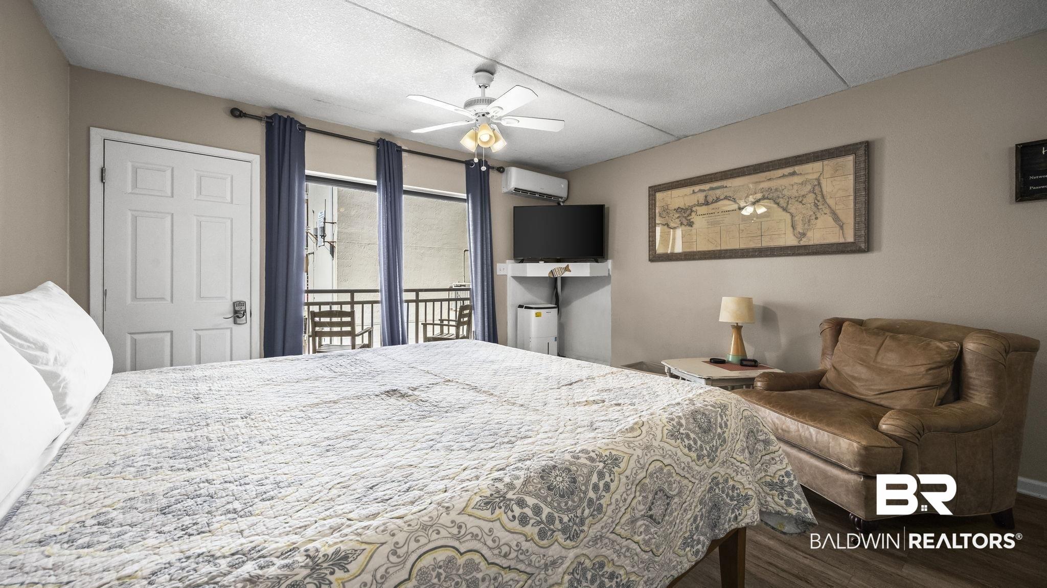 Image 3: Interior space with wood-finish flooring and neutral wall tones