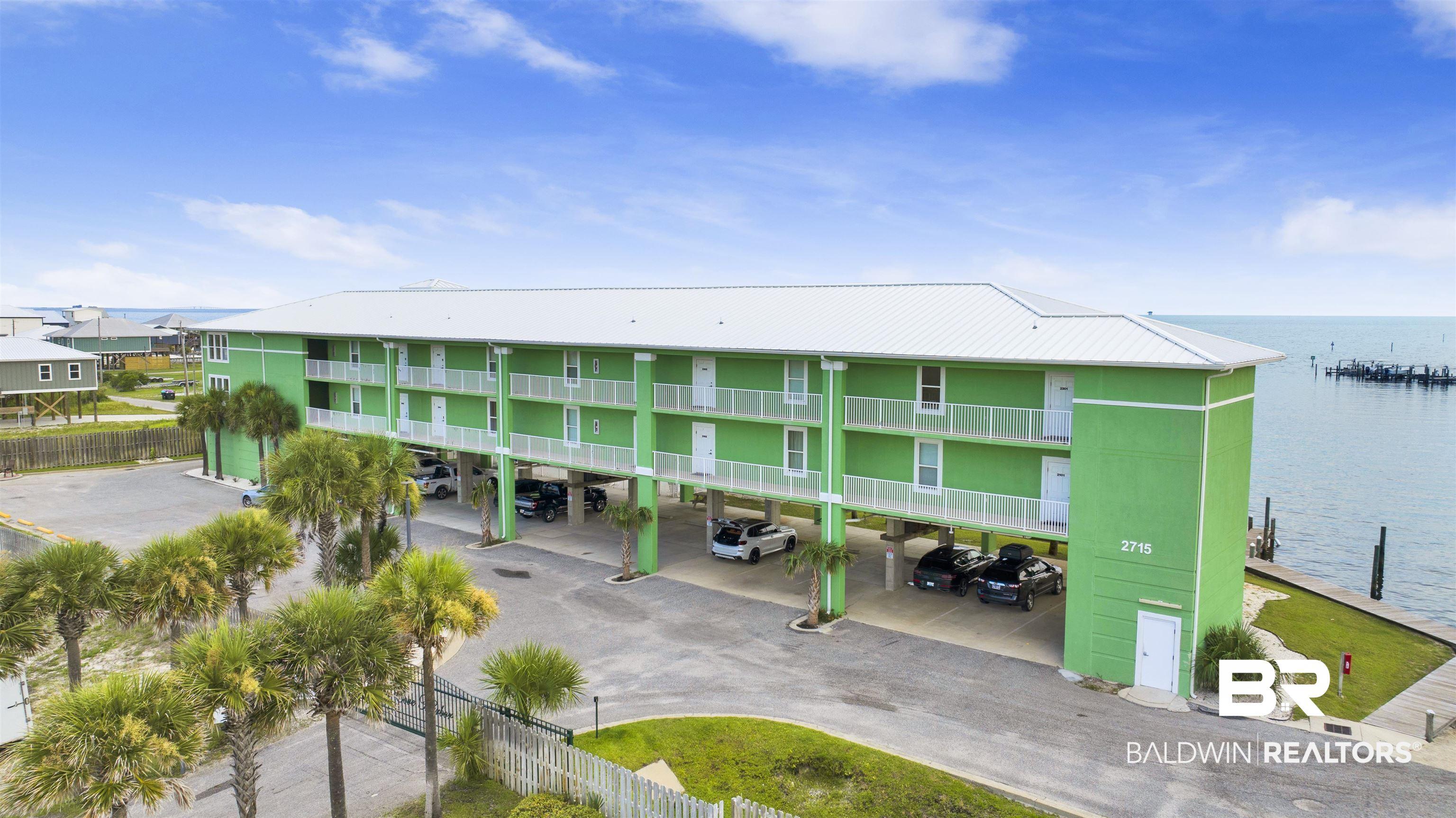 Image 3: View of property with covered parking and a water view