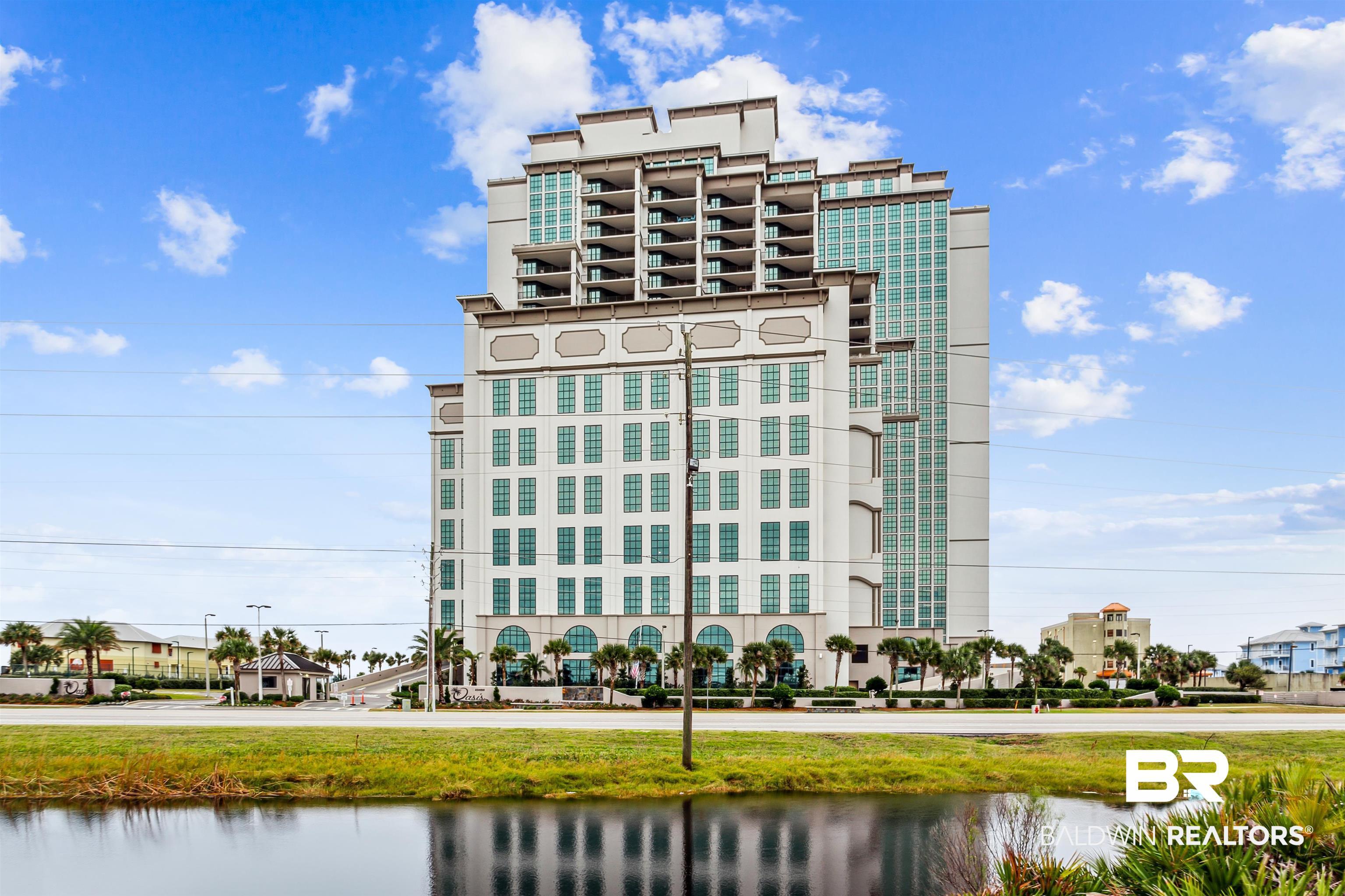 Image 2: Multi-story building featuring a stepped architectural design and extensive window fenestration