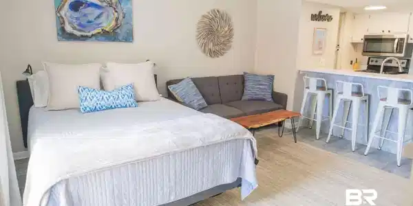 Image 2: Open-concept living area featuring light-toned walls, wood-finish flooring, and recessed lighting