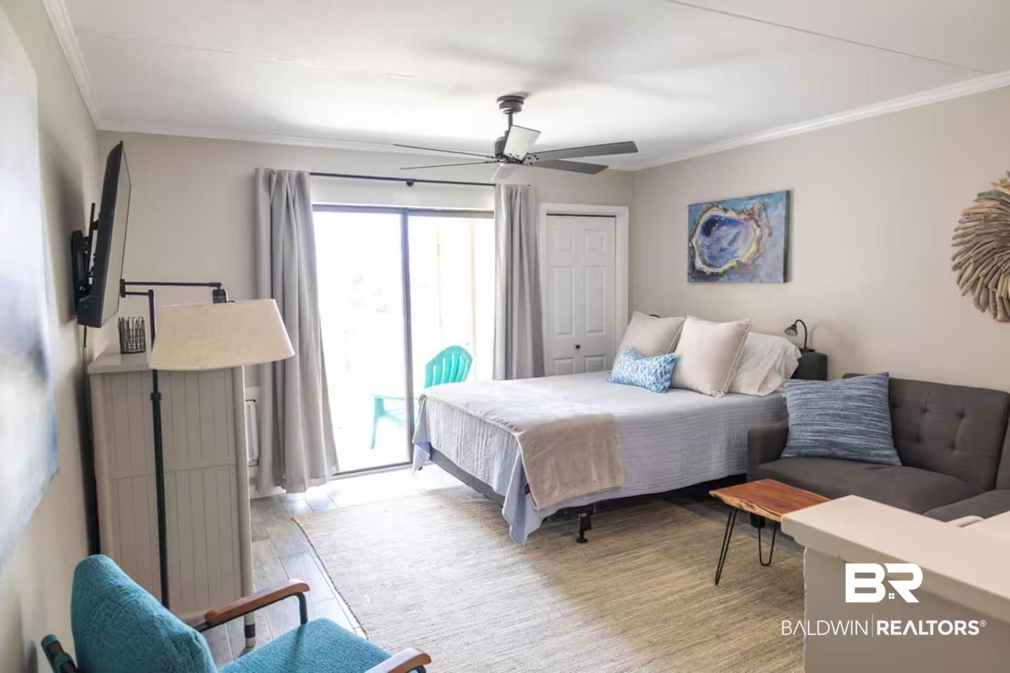 Image 3: Spacious room featuring wood-finish flooring, crown molding, and a ceiling fan