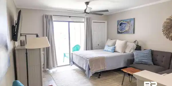 Image 3: Spacious room featuring wood-finish flooring, crown molding, and a ceiling fan