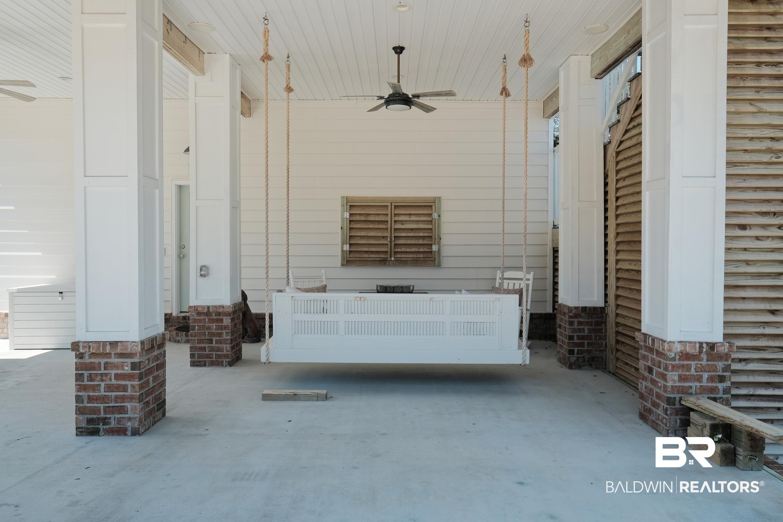 Image 2: Covered porch with a ceiling fan