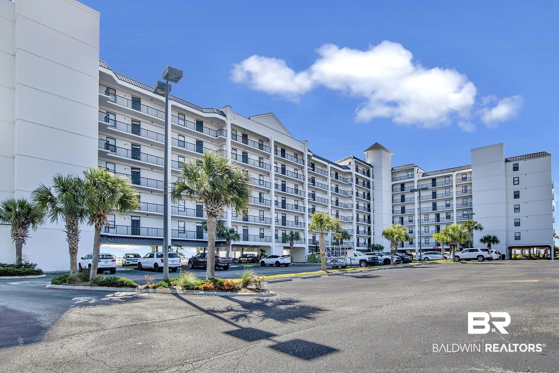 Image 2: View of apartment building / complex with uncovered parking