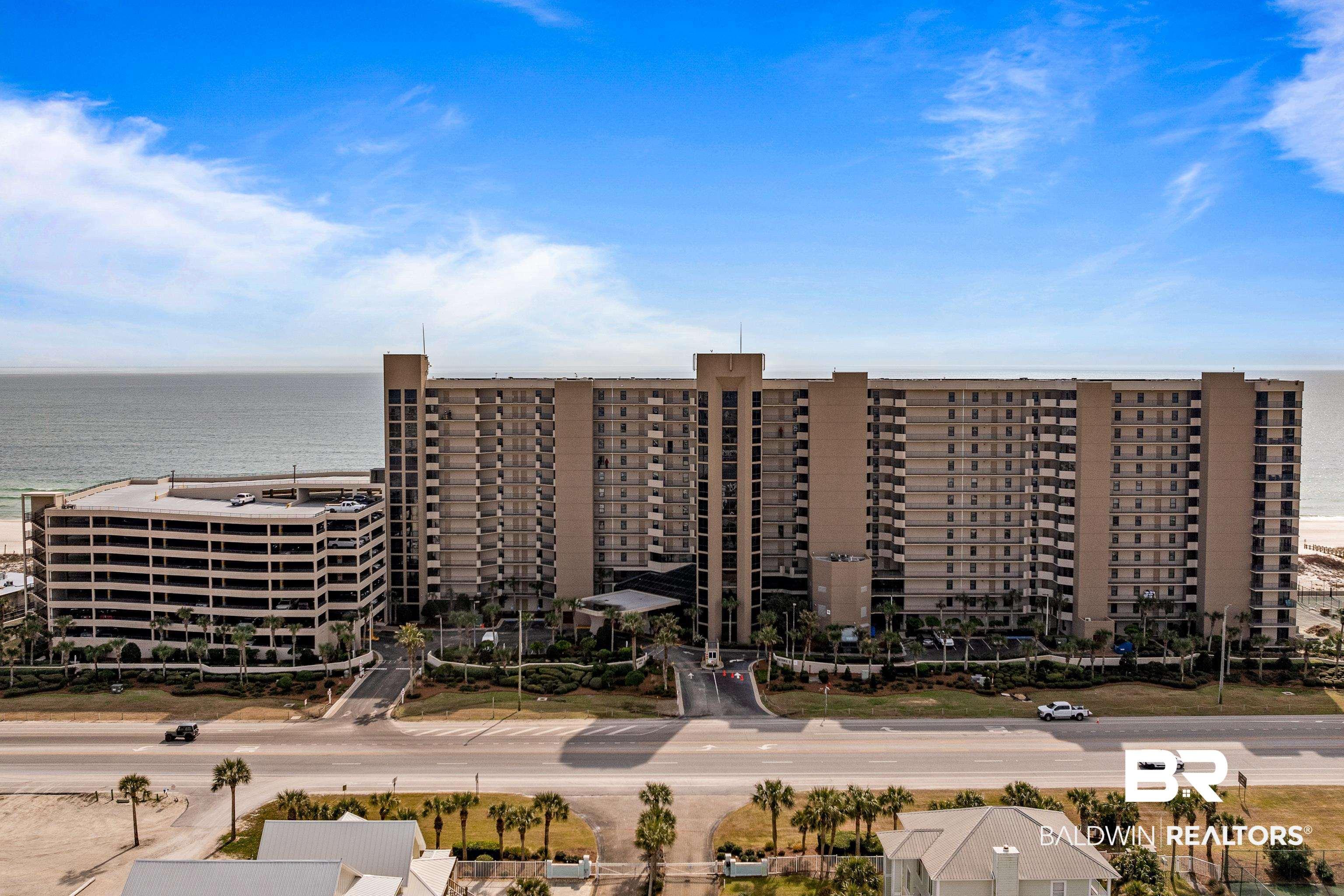 Image 1: Aerial view of apartment complex / building and a nearby body of water