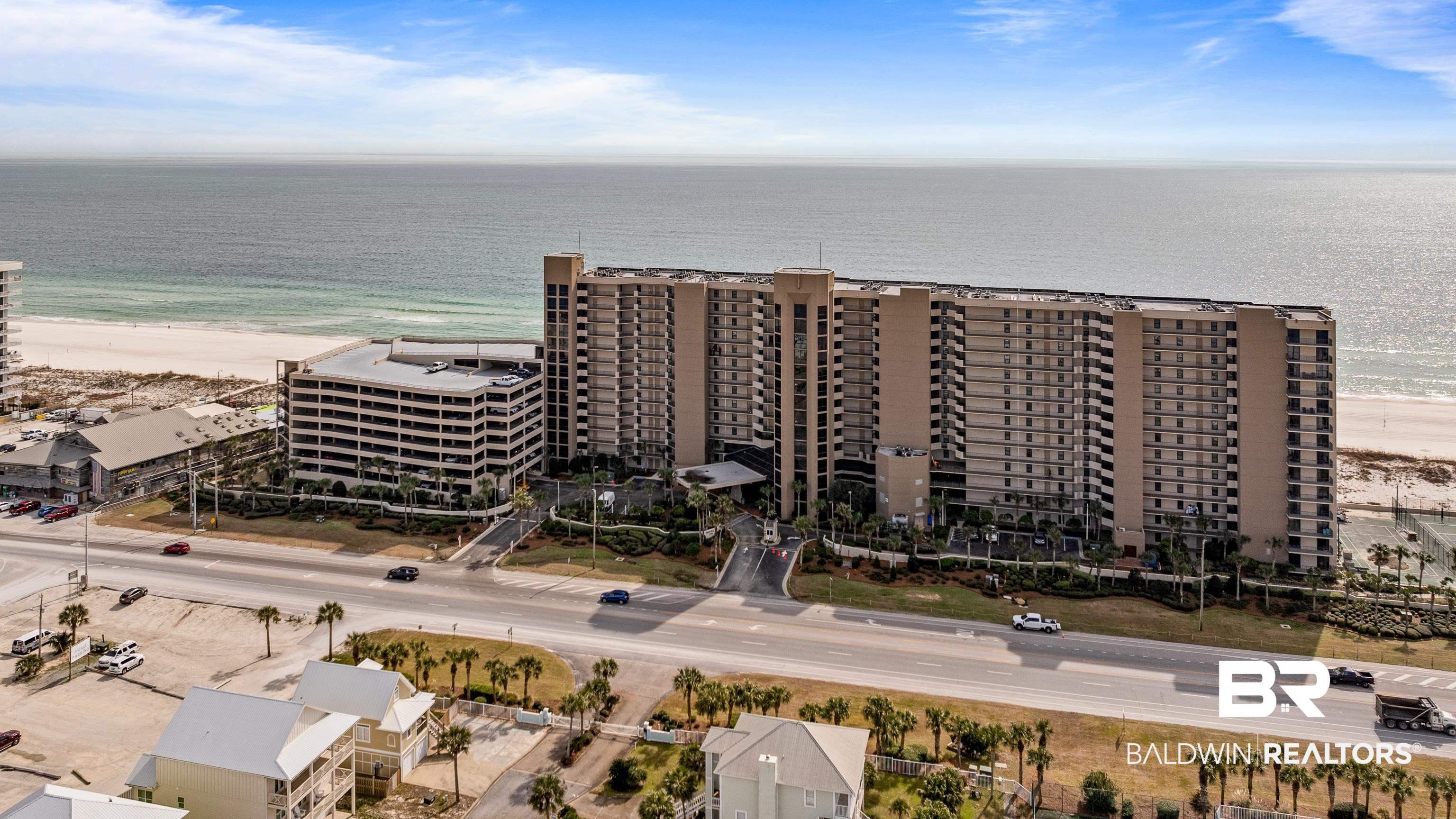 Image 2: Aerial view of apartment complex and a large body of water