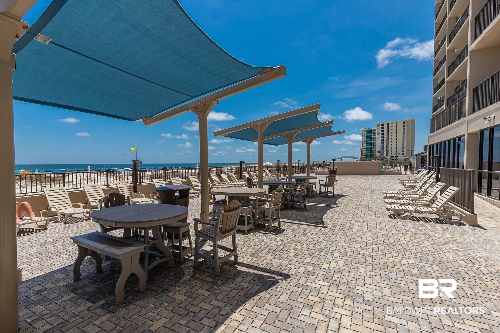 Image 2: View of patio featuring a water view and outdoor dining area