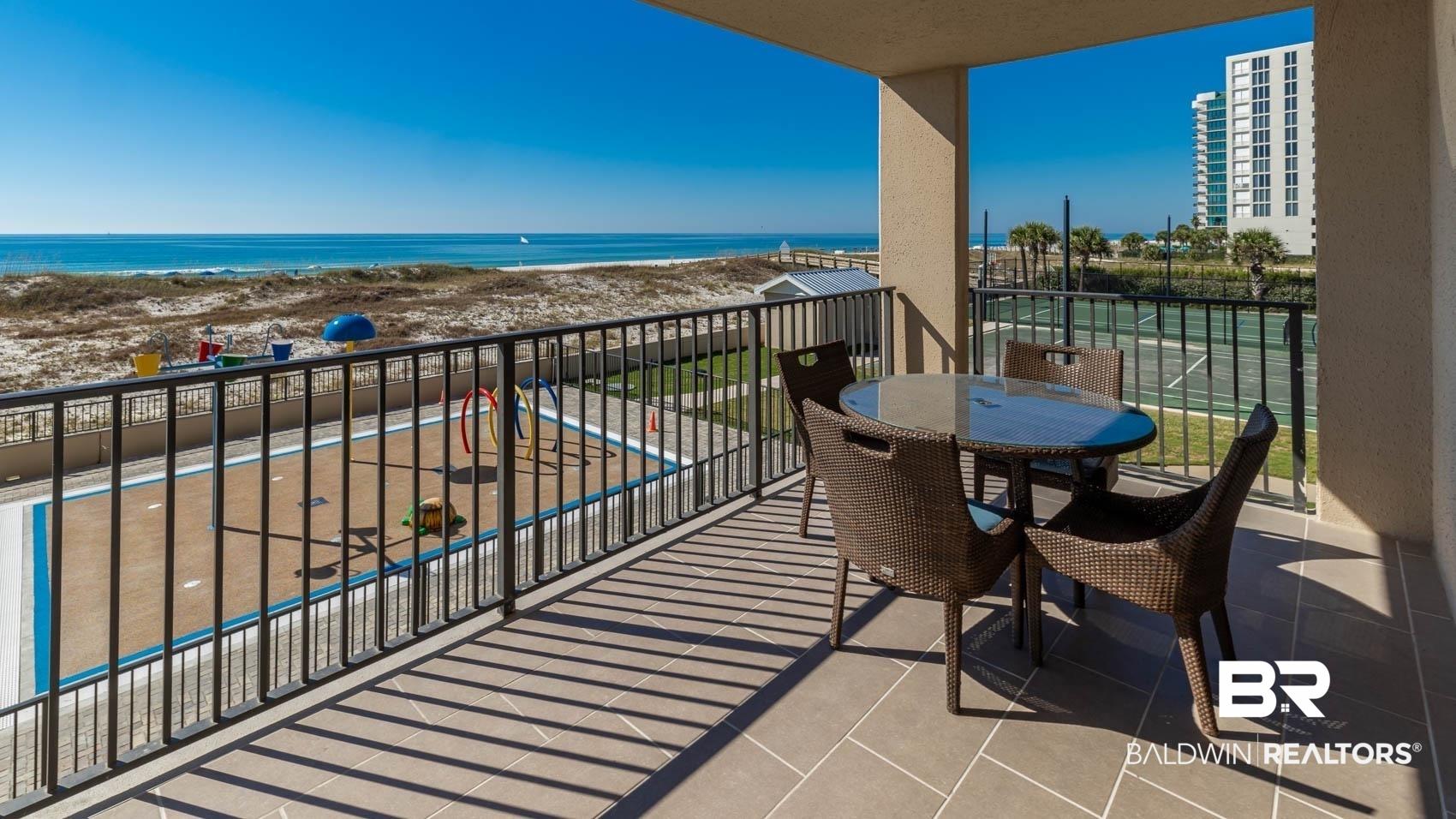 Image 3: Balcony with a water view and outdoor dining area