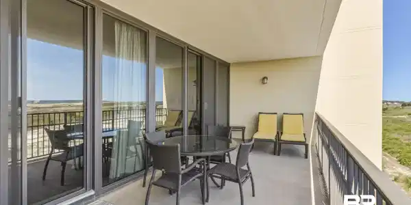 Image 4: Expansive private balcony featuring a concrete surface and a metal railing