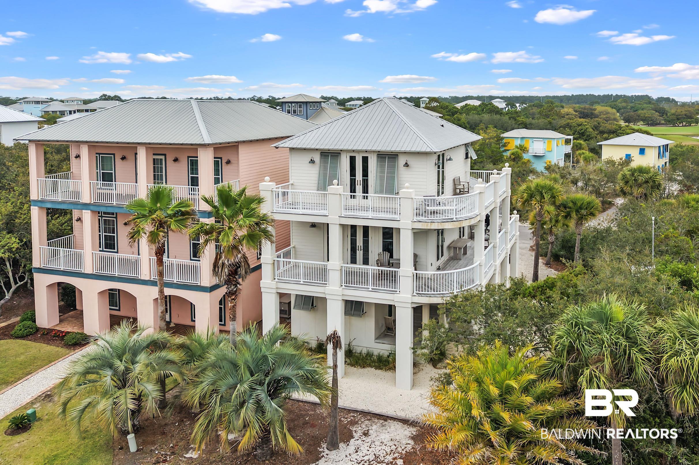 Image 1: Elevated coastal residence featuring multiple expansive balconies with white railings, a light-colored exterior, and a metal roof