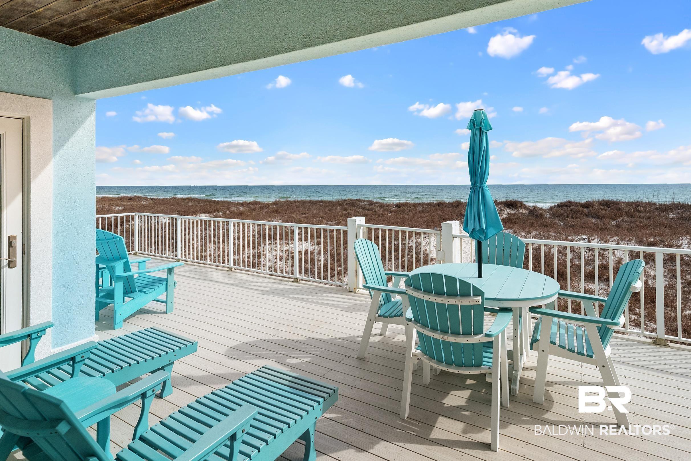 Image 3: Wooden terrace with a water view and outdoor dining space