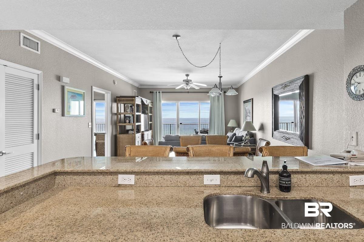 Image 3: Kitchen with granite-style countertops and a stainless steel double-basin sink