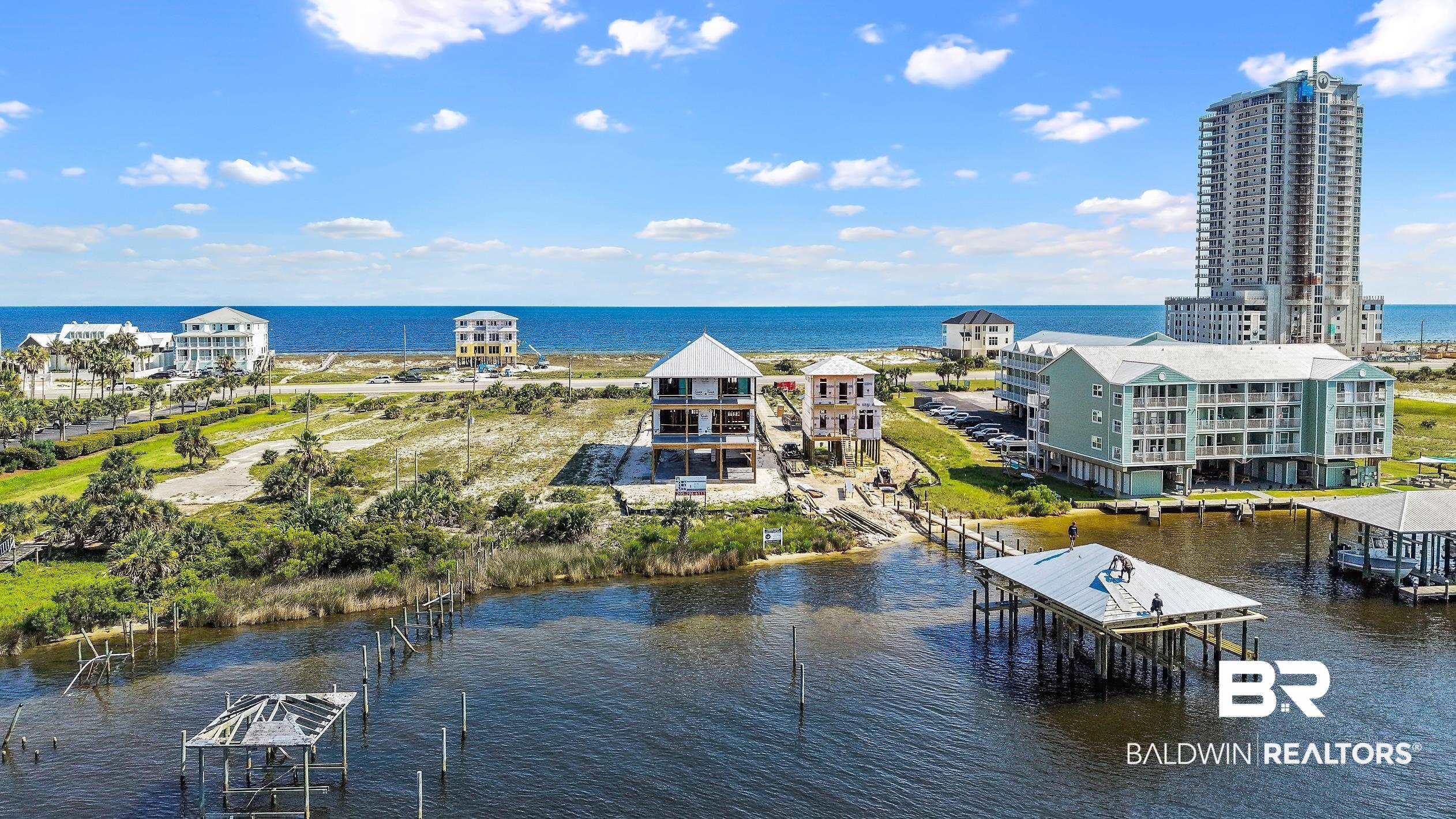 Image 3: Waterfront property featuring a private boat dock, direct water access, a raised foundation structure, and a coastal architectural style