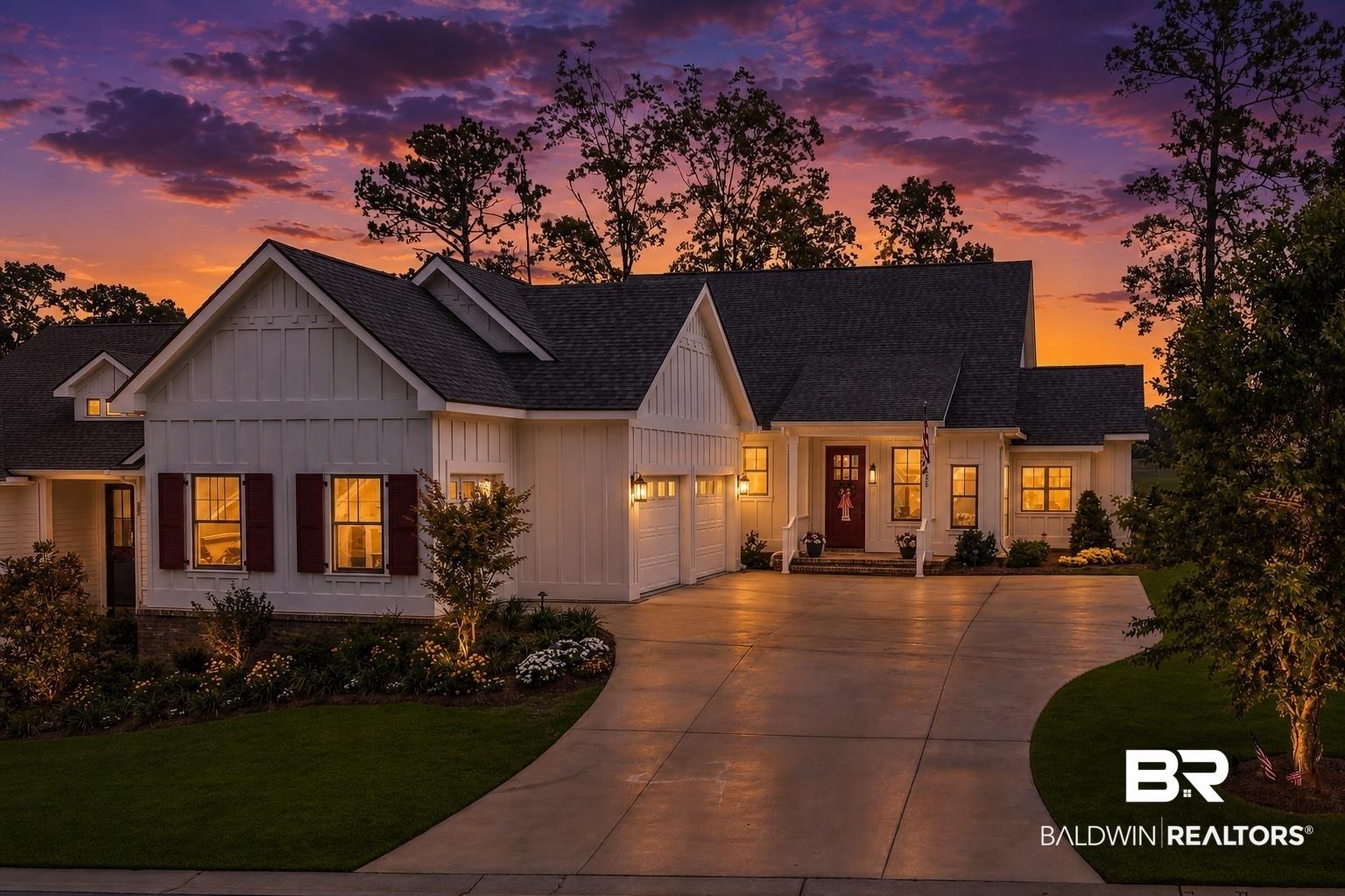 Image 1: Craftsman-style home featuring white board and batten siding, dark shingle roofing, and a prominent three-car garage