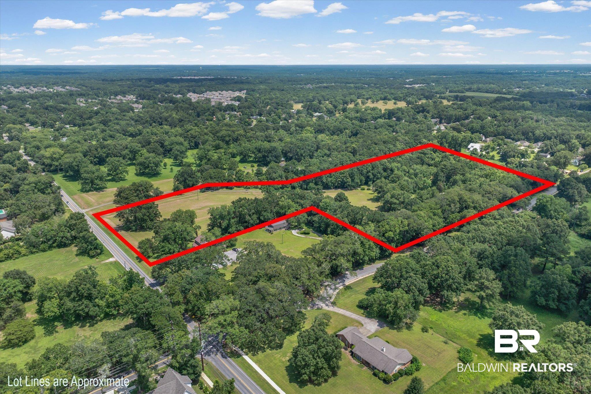 Image 2: Expansive property offering a blend of open fields and dense woodlands