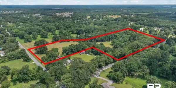 Image 2: Expansive property offering a blend of open fields and dense woodlands