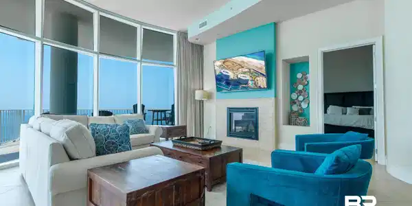 Image 3: Tiled living room with expansive windows, a tile fireplace, and ceiling fan