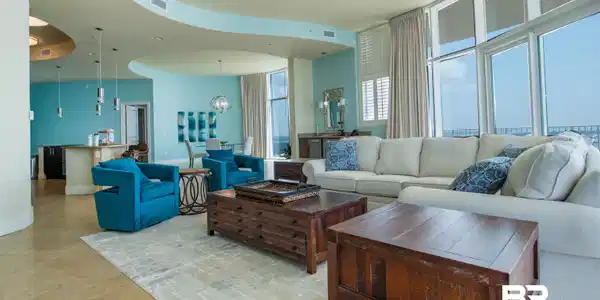 Image 4: Living room with light tile patterned floors and a chandelier