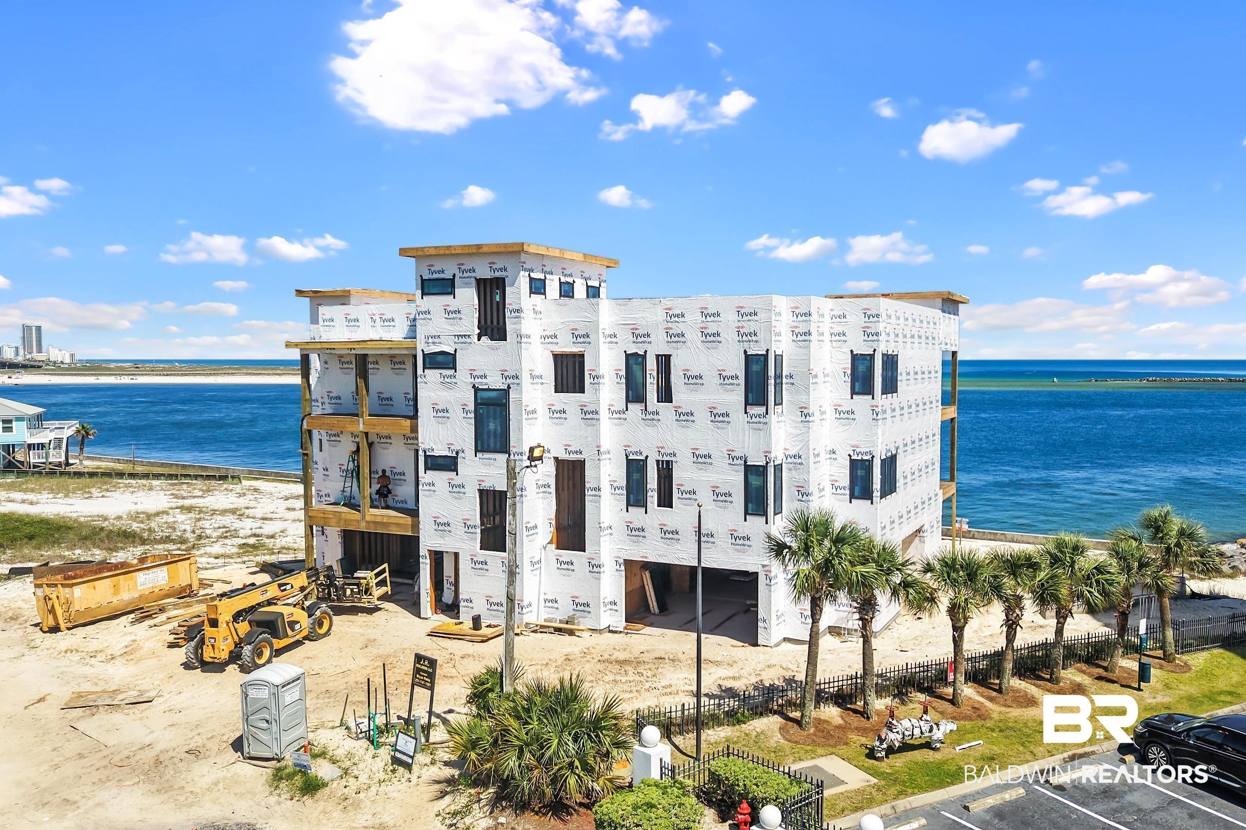 Image 4: Multi-level building under construction with a water backdrop