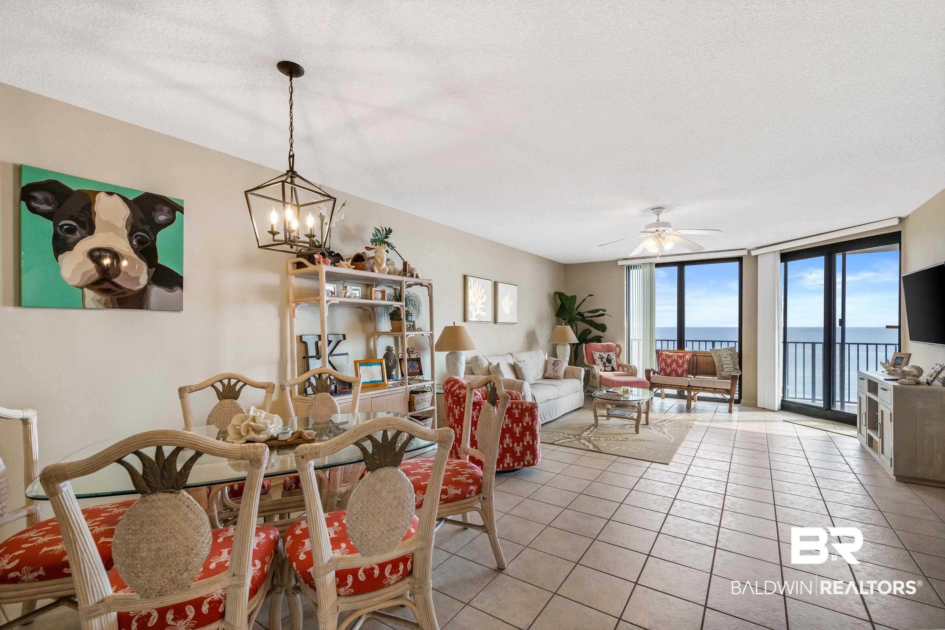 Image 4: Tiled dining space with a wall of windows, a ceiling fan, a textured ceiling, and a chandelier