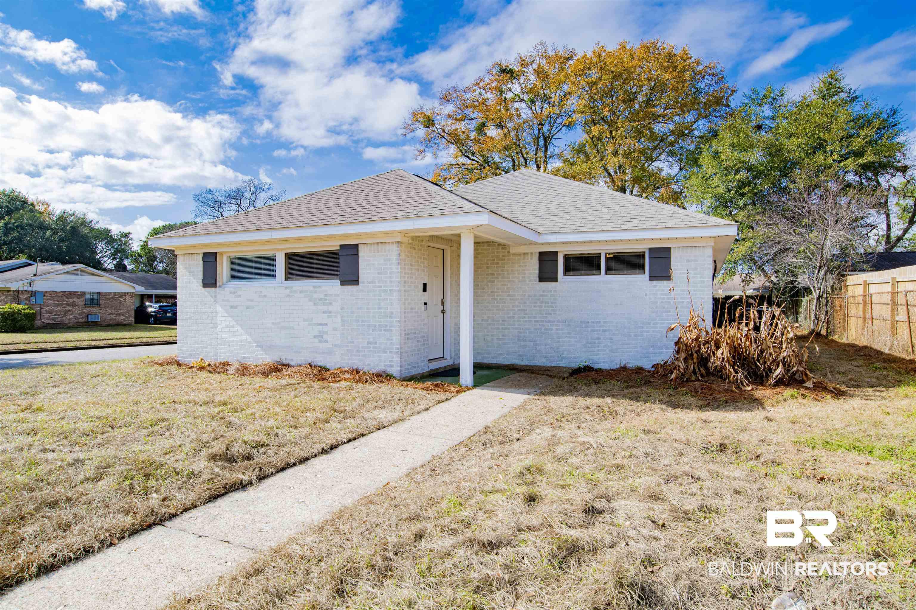Image 2: Single story home featuring brick siding and roof with shingles