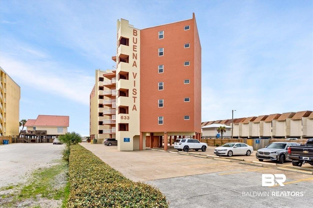 Image 1: View of apartment building / complex featuring uncovered parking
