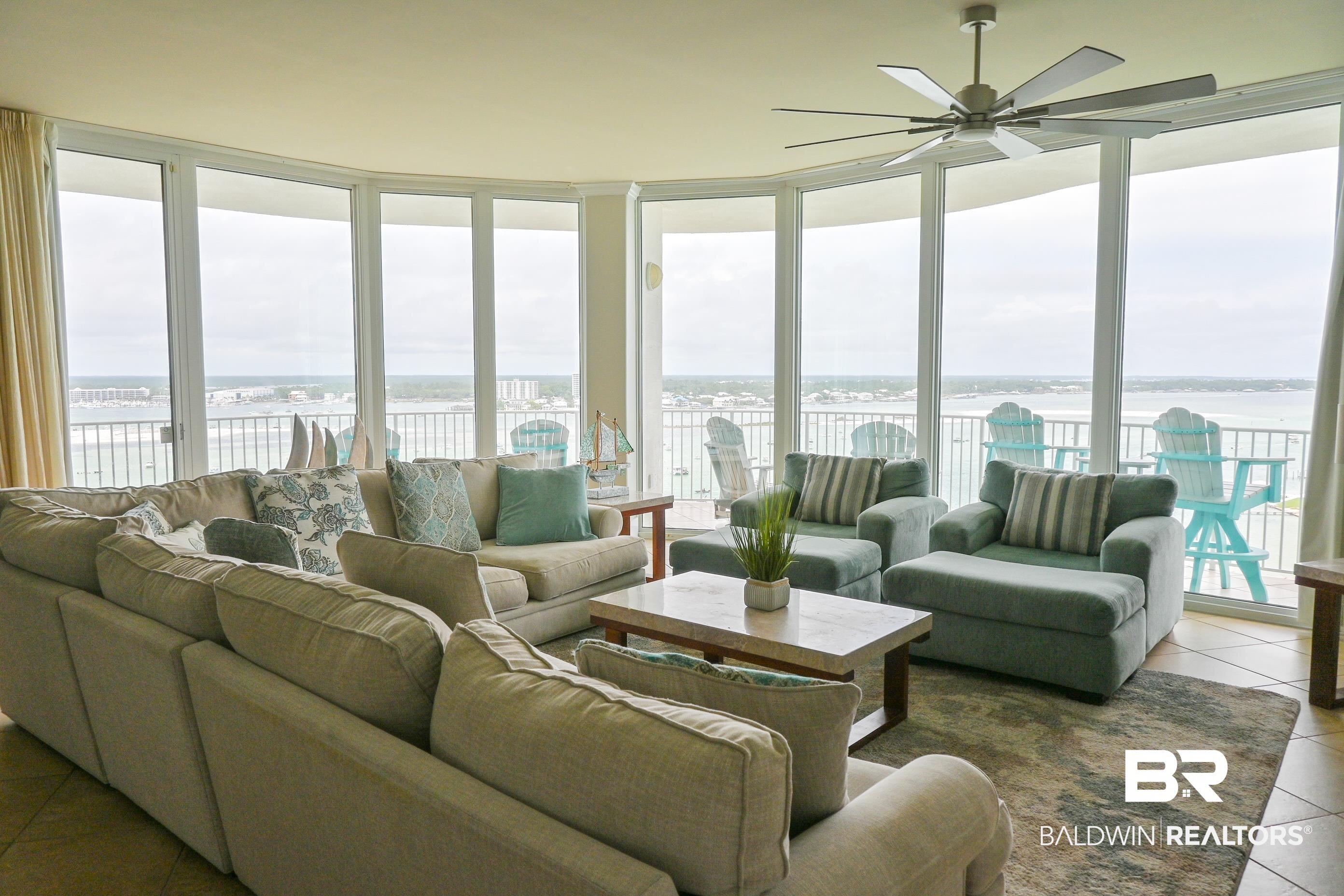 Image 2: Curved wall of floor-to-ceiling windows with expansive water and shoreline vistas