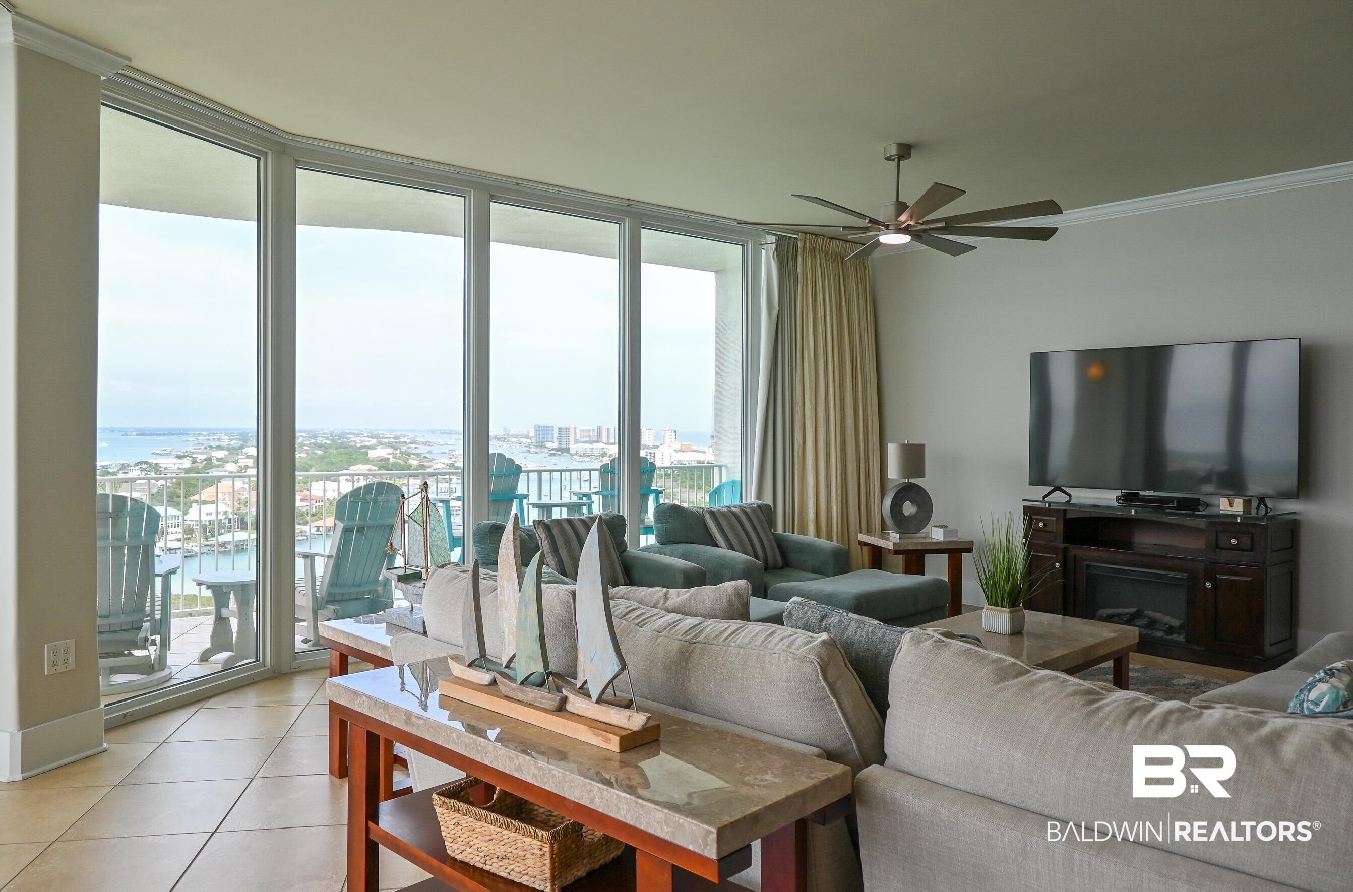 Image 4: Bright living area with full-height sliding glass doors opening to a balcony