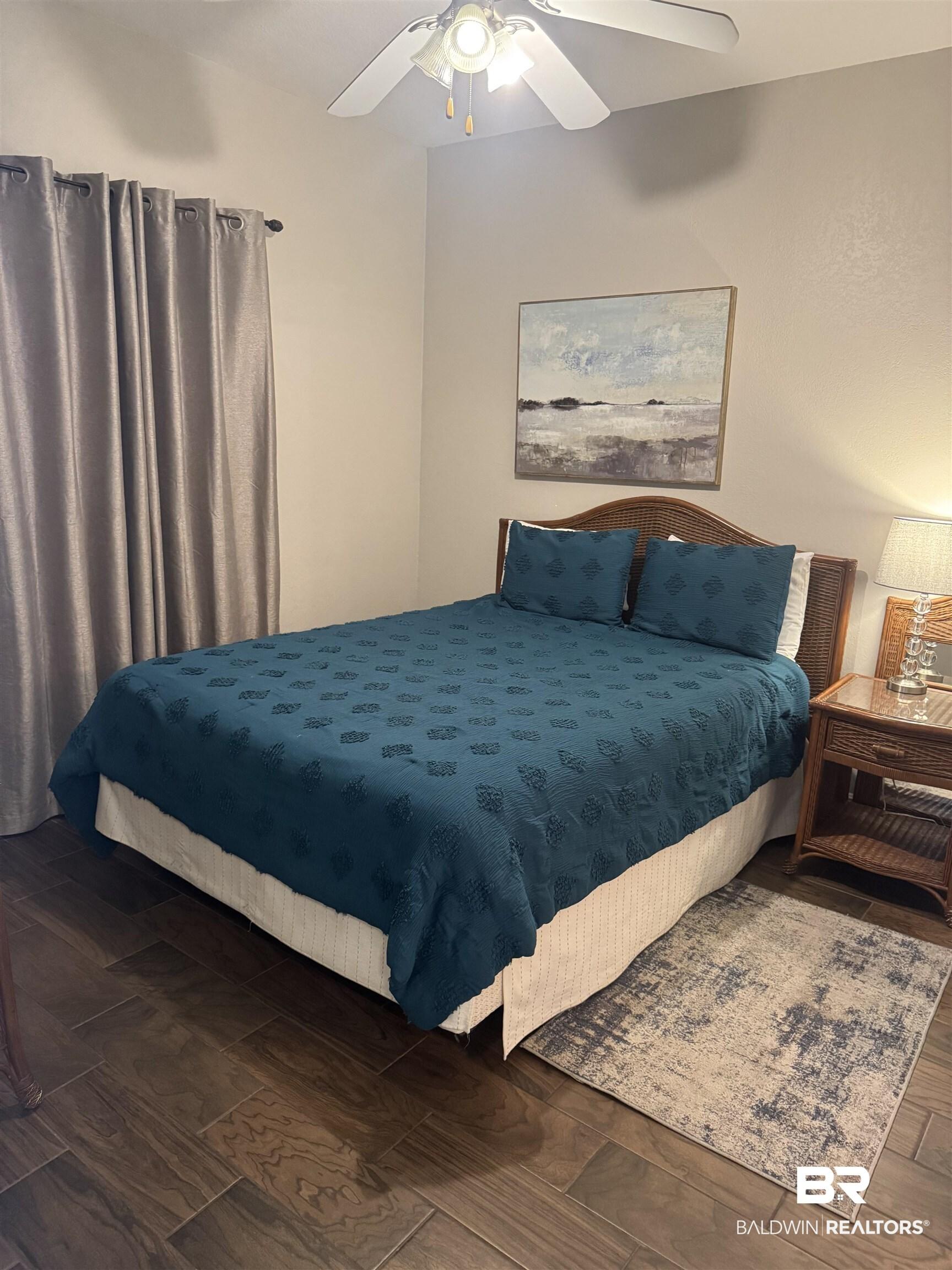 Image 2: Bedroom with wood finished floors and ceiling fan